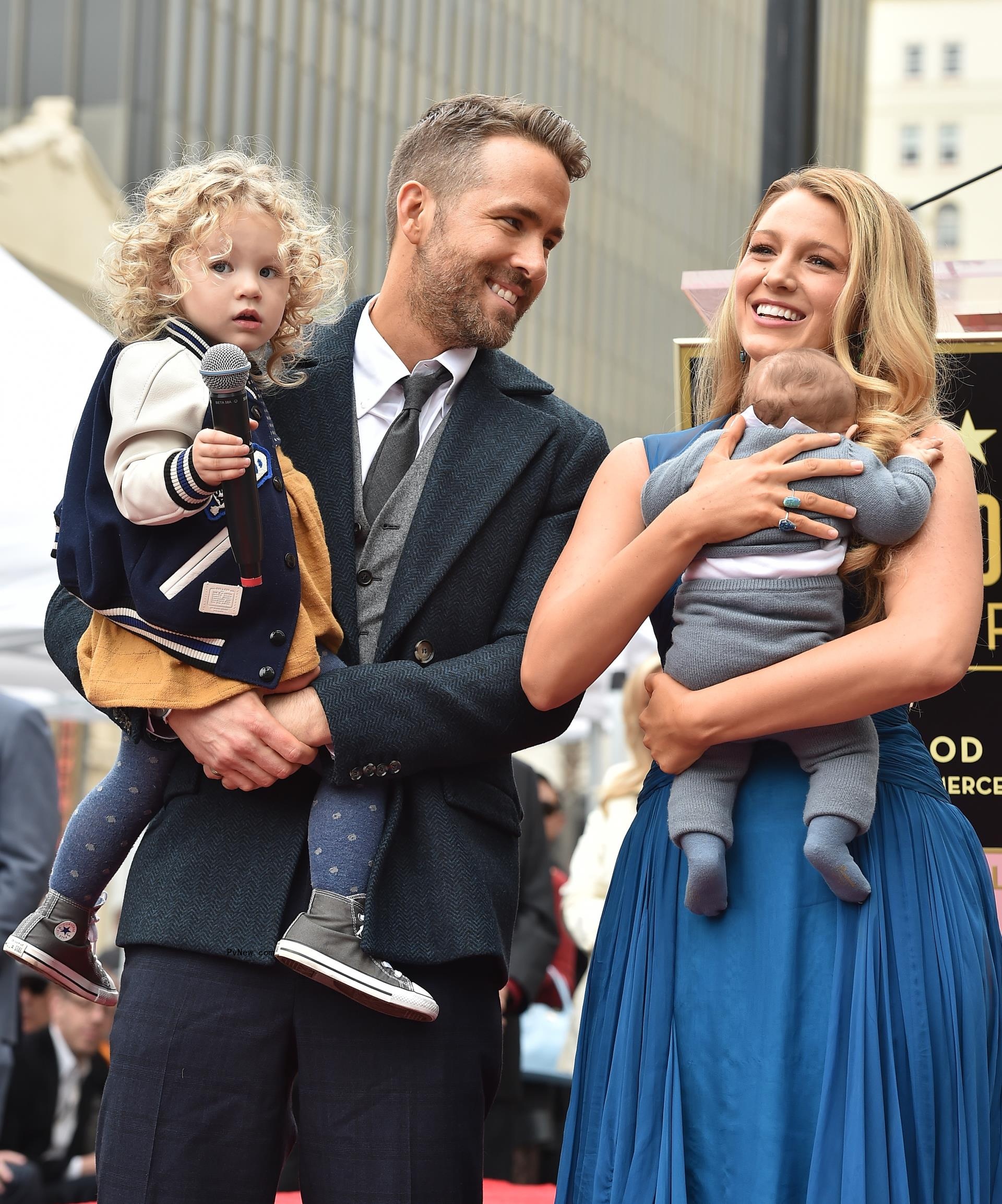 Ryan Reynolds and Blake Lively posing with their daughters