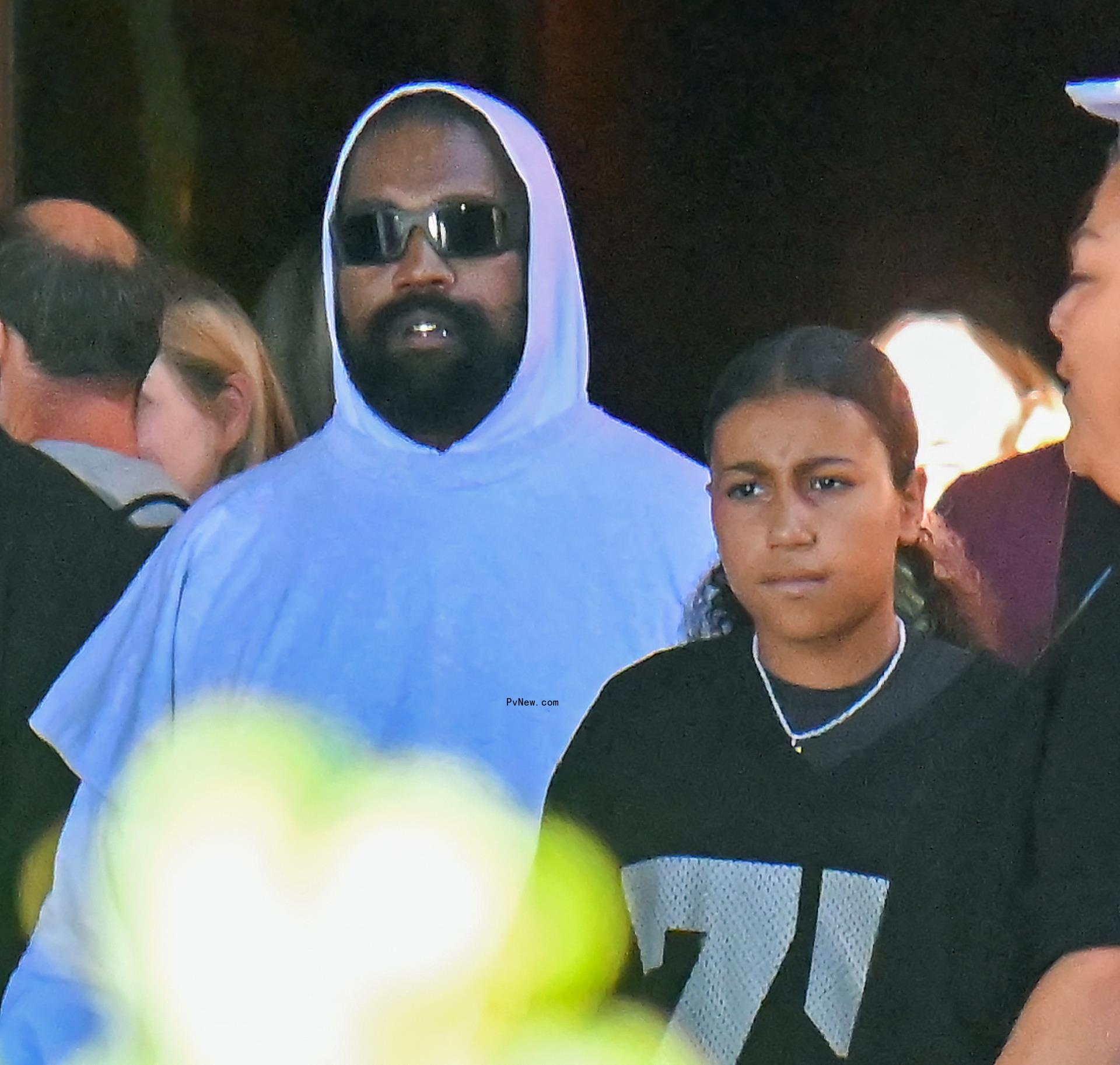 Kanye West and North West walking together