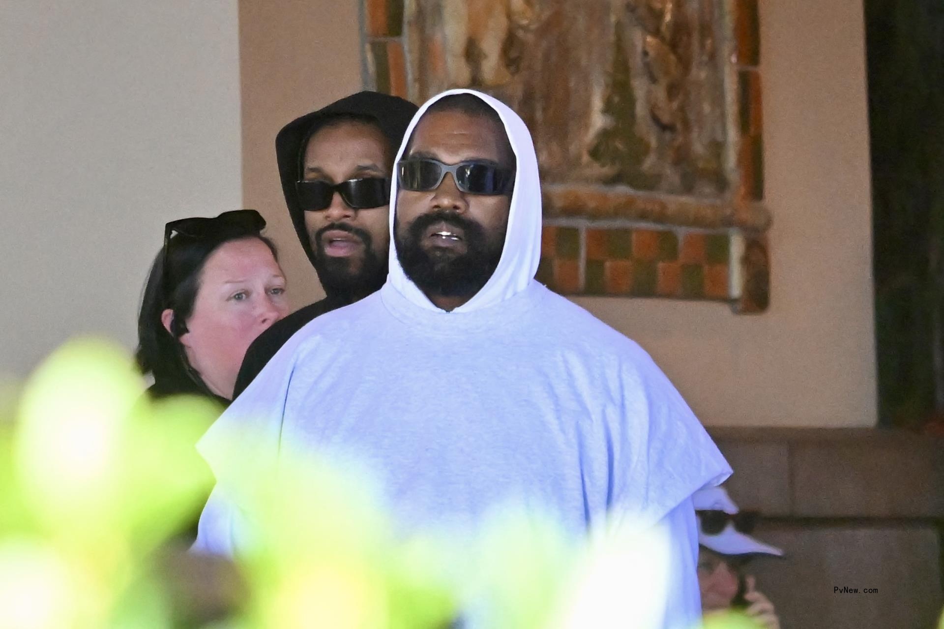 Kanye West and North West walking together
