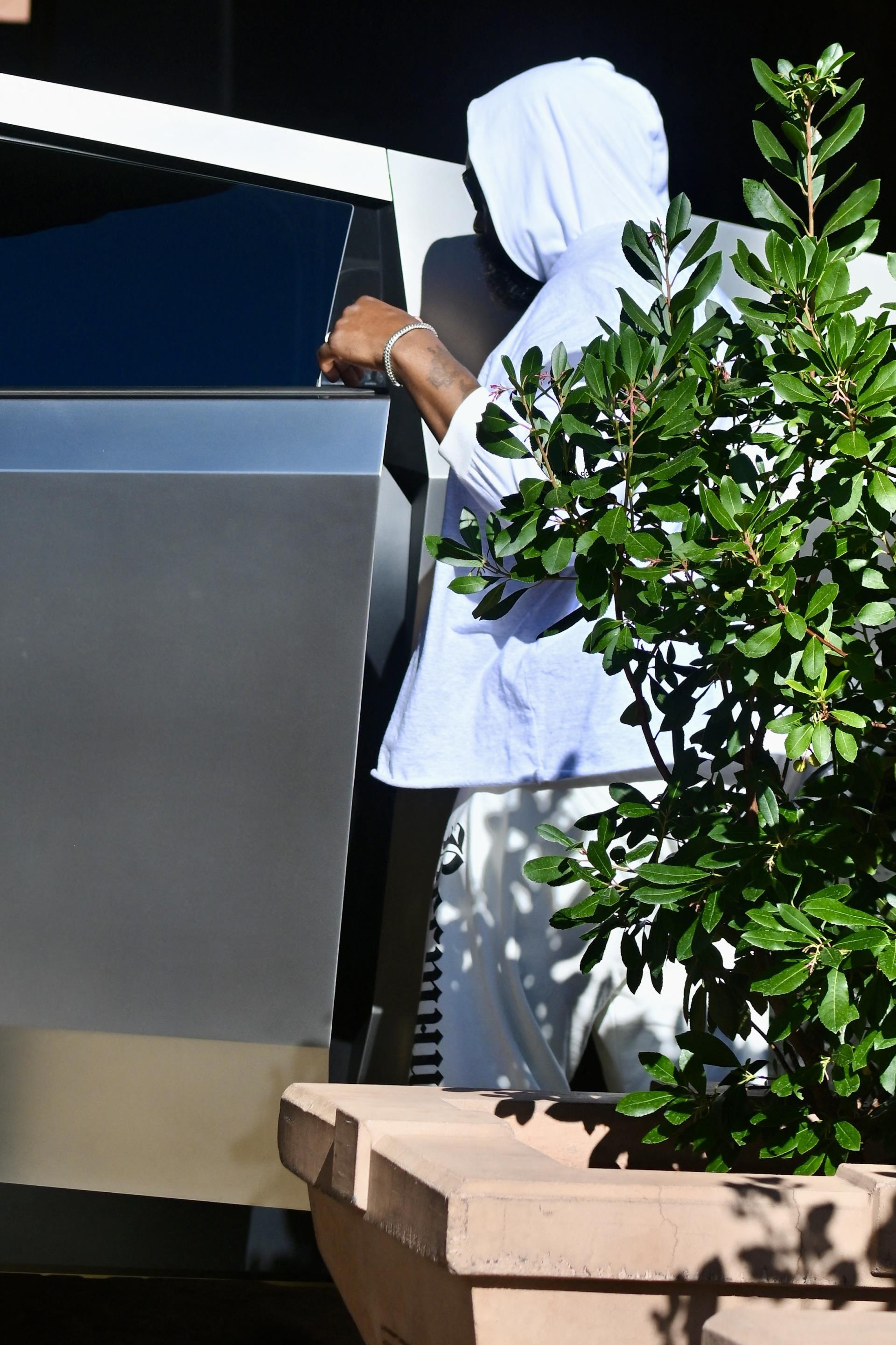 The side of Kanye West walking