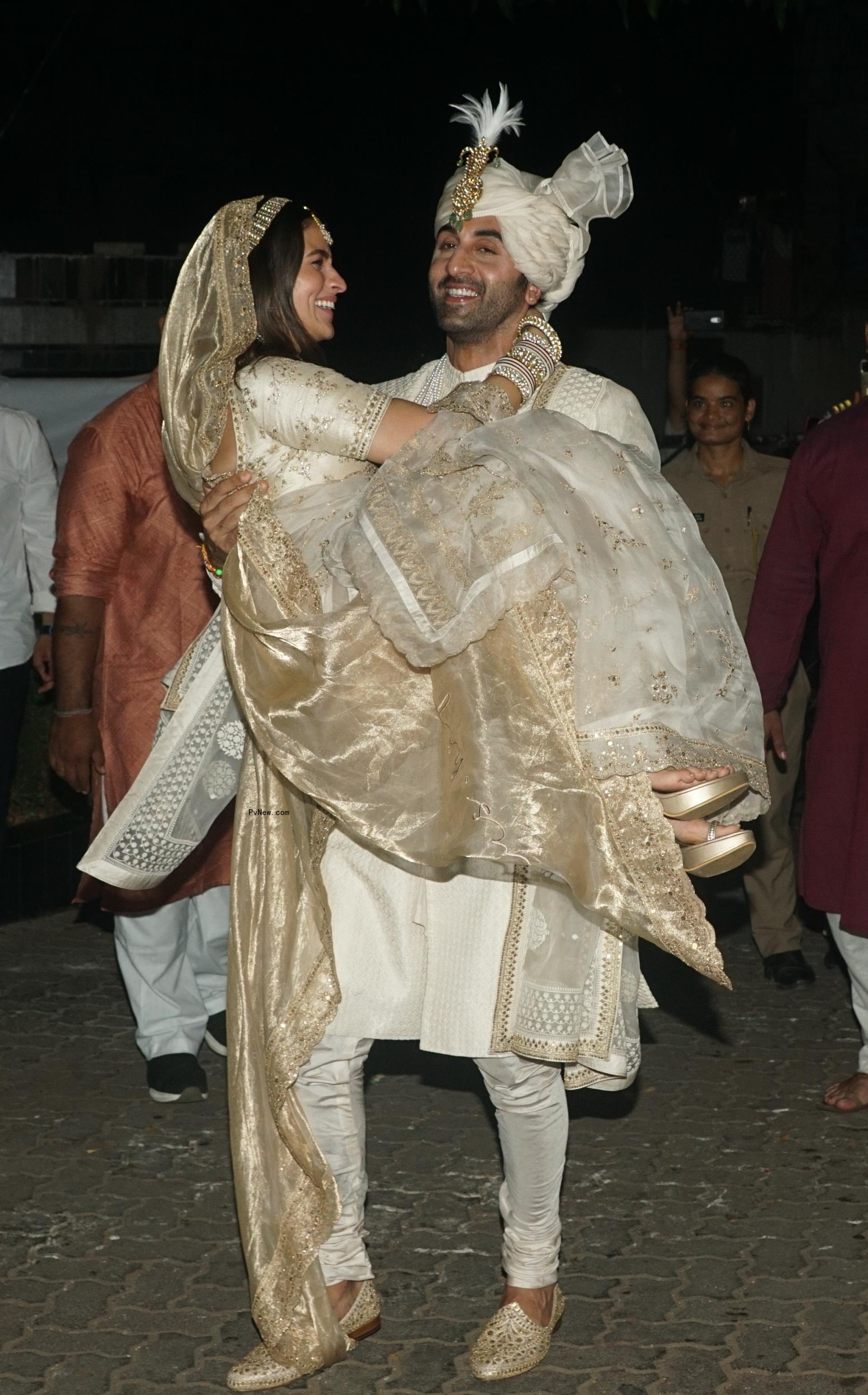 Ranbir Kapoor holding Alia Bhatt during their wedding.