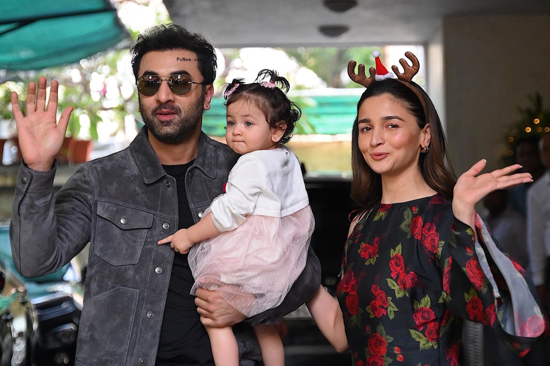Ranbir Kapoor, Alia Bhatt and their daughter, Raha, waving to photographers.