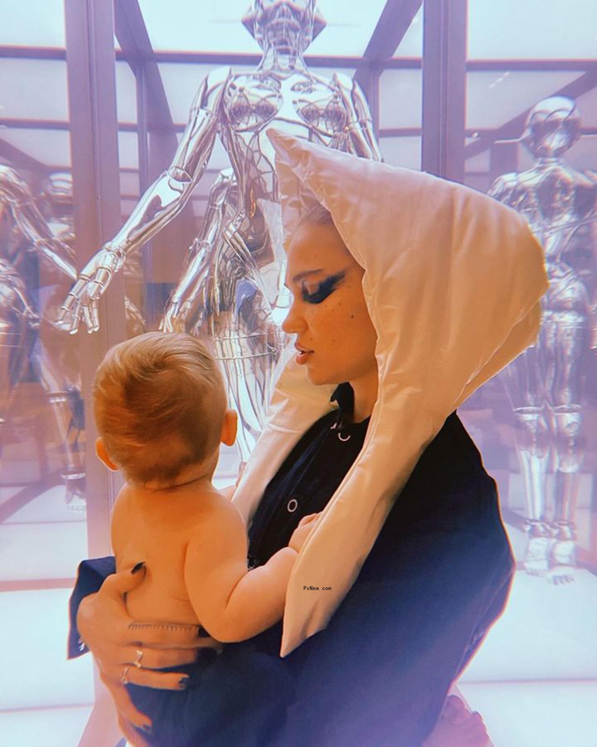 Grimes holding her child