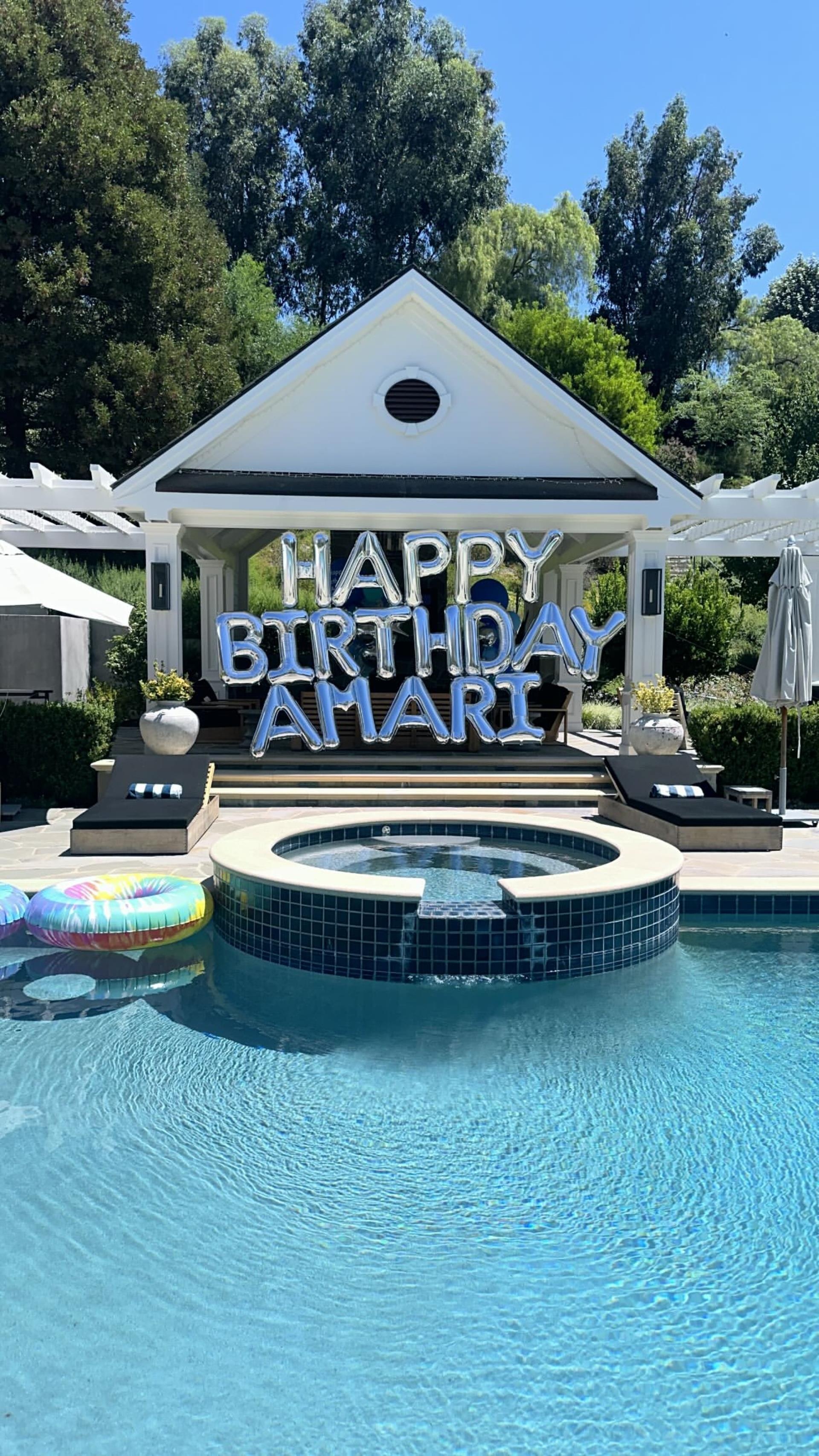 Happy birthday Amari balloons by the pool.