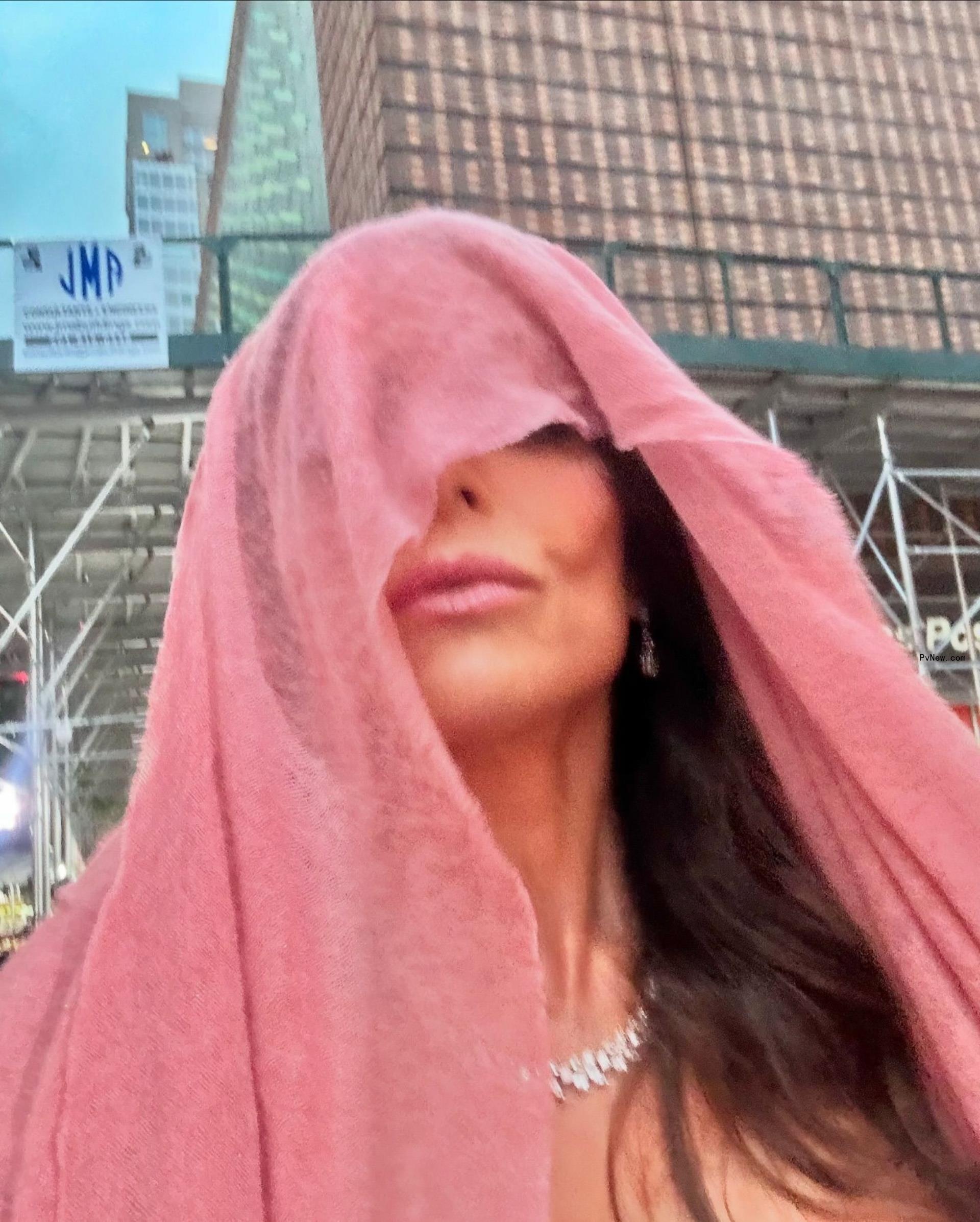 Bethenny Frankel with a towel over her head