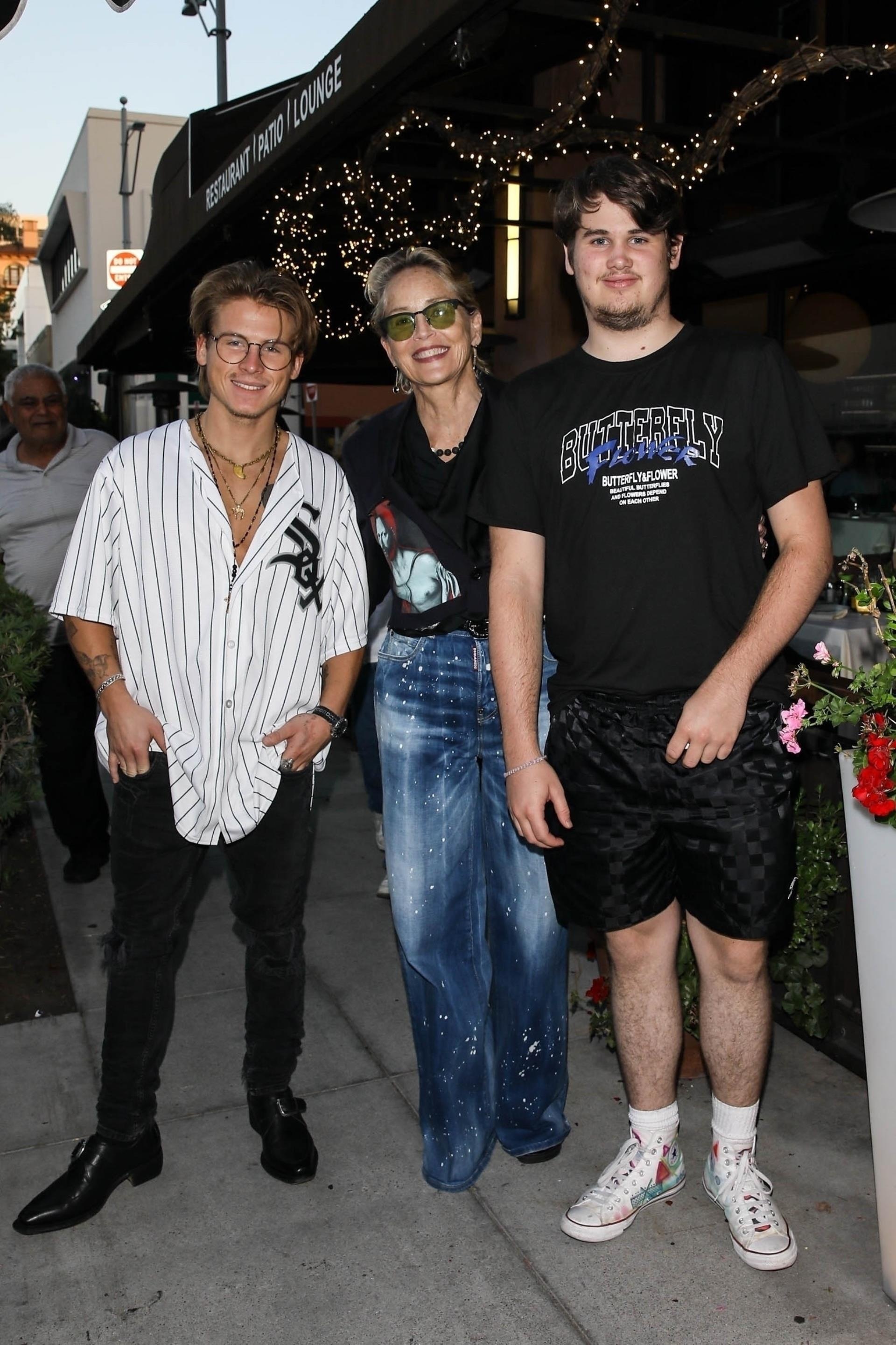 Sharon Stone poses for a picture with her two sons Roan and Laird after lunch at Via Alloro Italian restaurant in Beverly Hills.