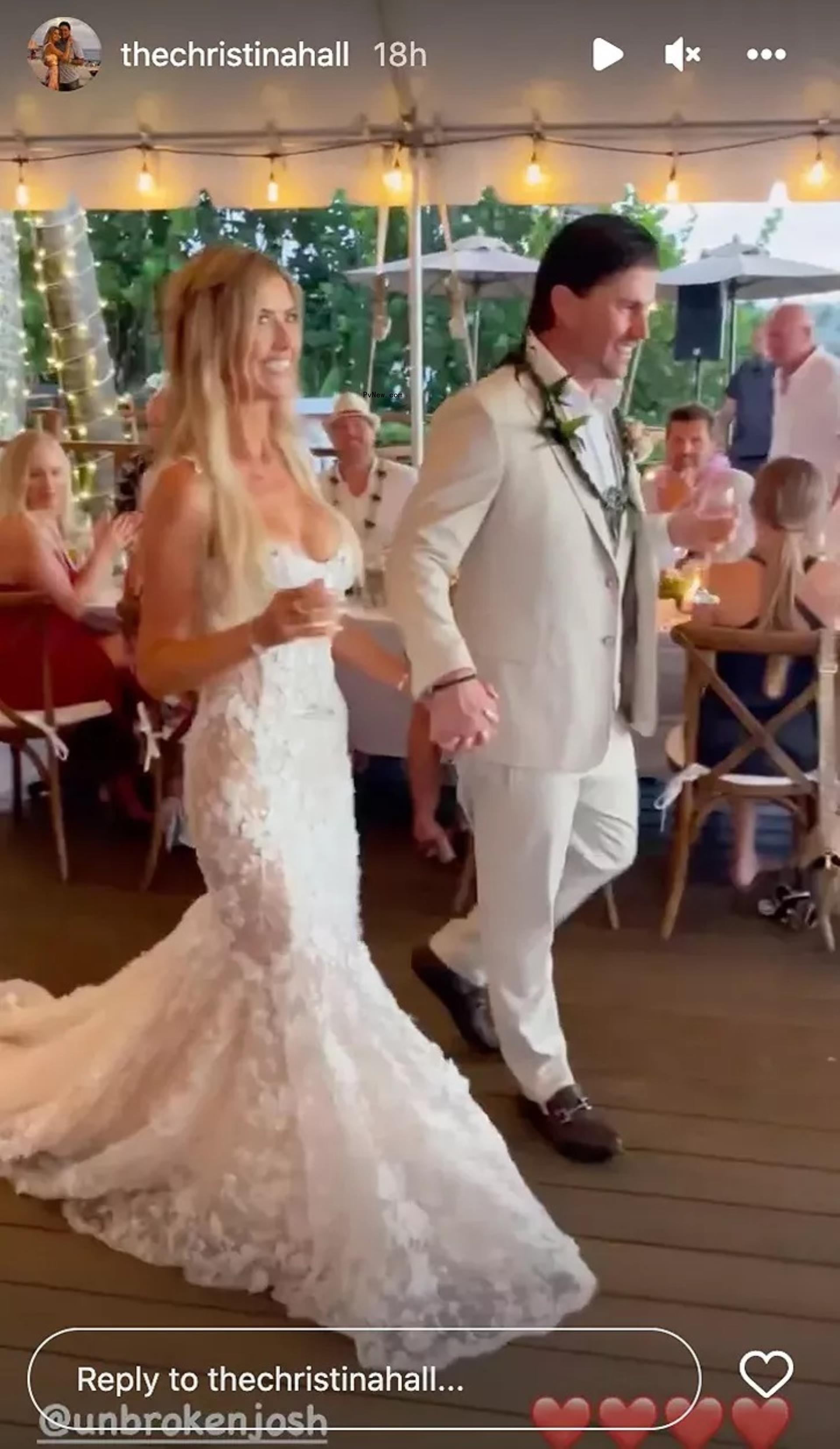 Christina Hall holding hands with Josh Hall during their 2022 wedding.