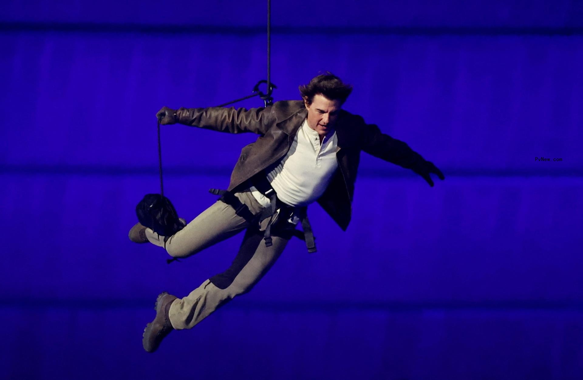 Actor Tom Cruise performs a stunt during the closing ceremony at the Paris 2024 Olympics. 