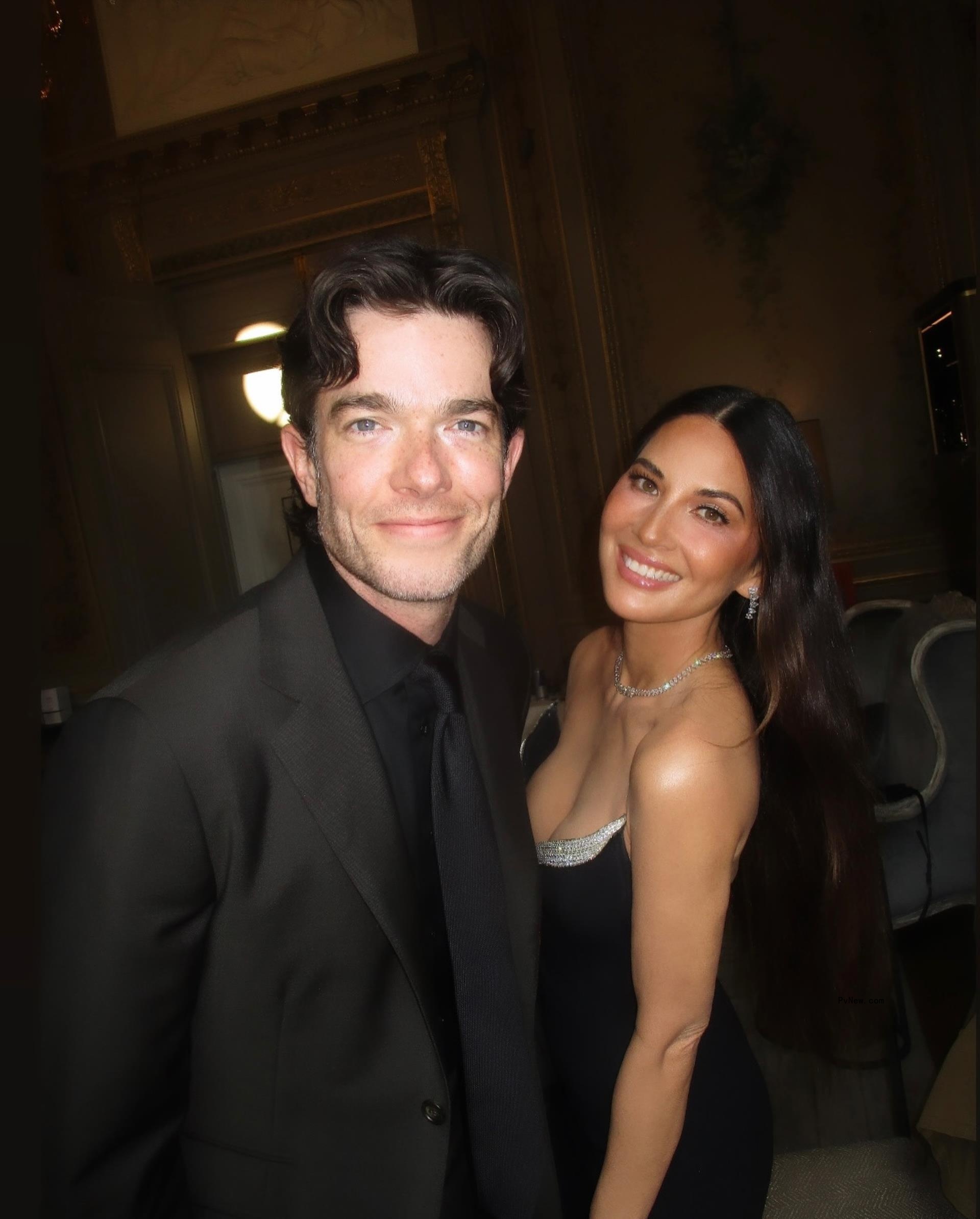 Olivia Munn and John Mulaney at an event. 