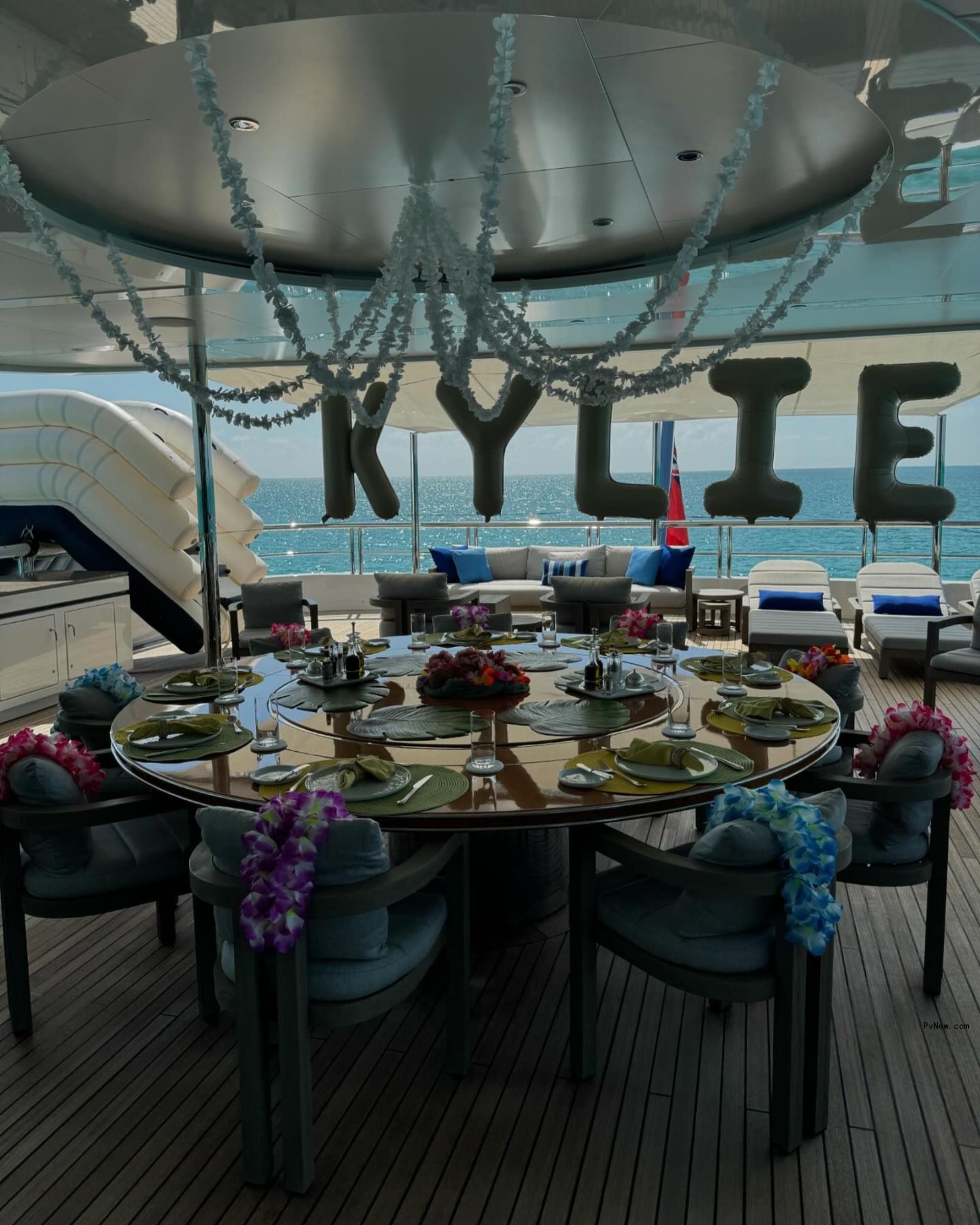 a deck of a yacht with KYLIE balloons