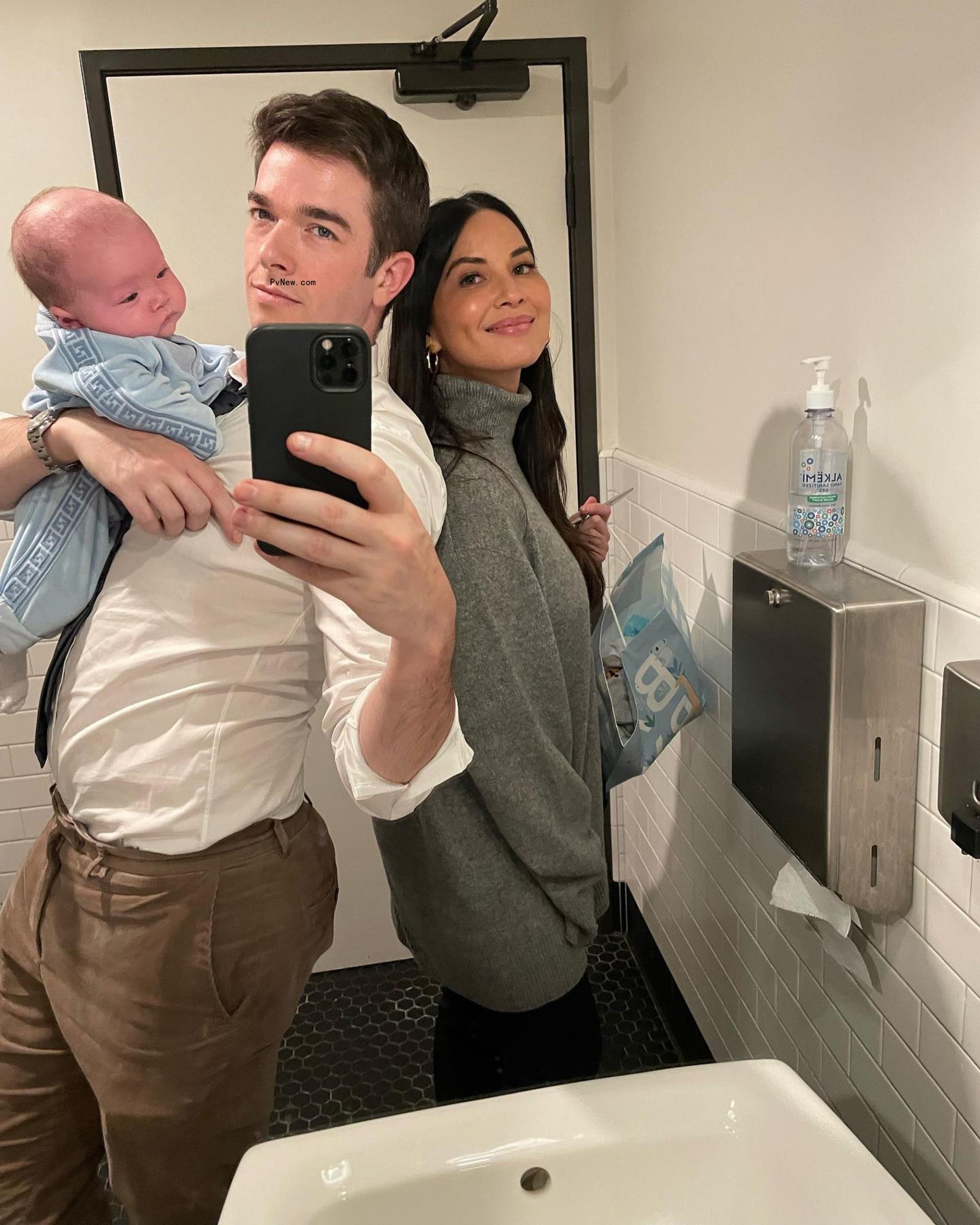 john mulaney taking a mirror selfie of himself, olivia munn and their baby