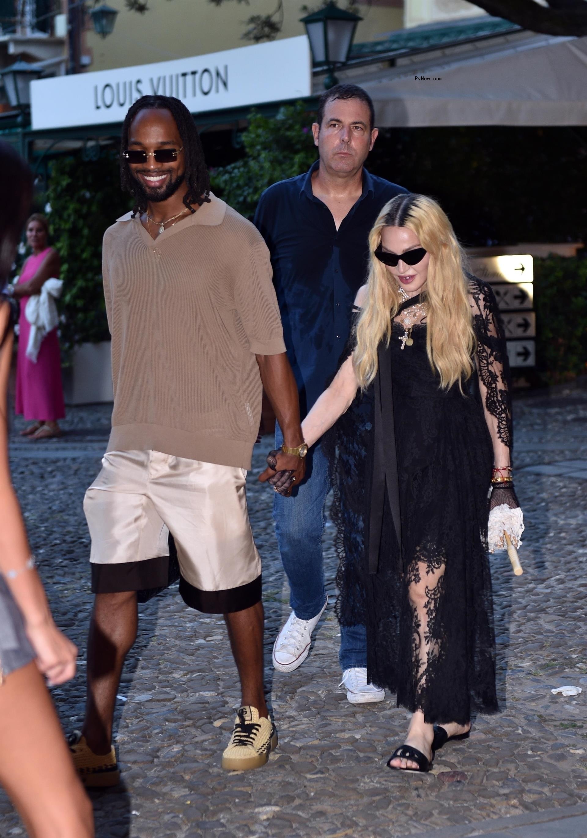 Mado<i></i>nna and Akeem Morris holding hands in Italy