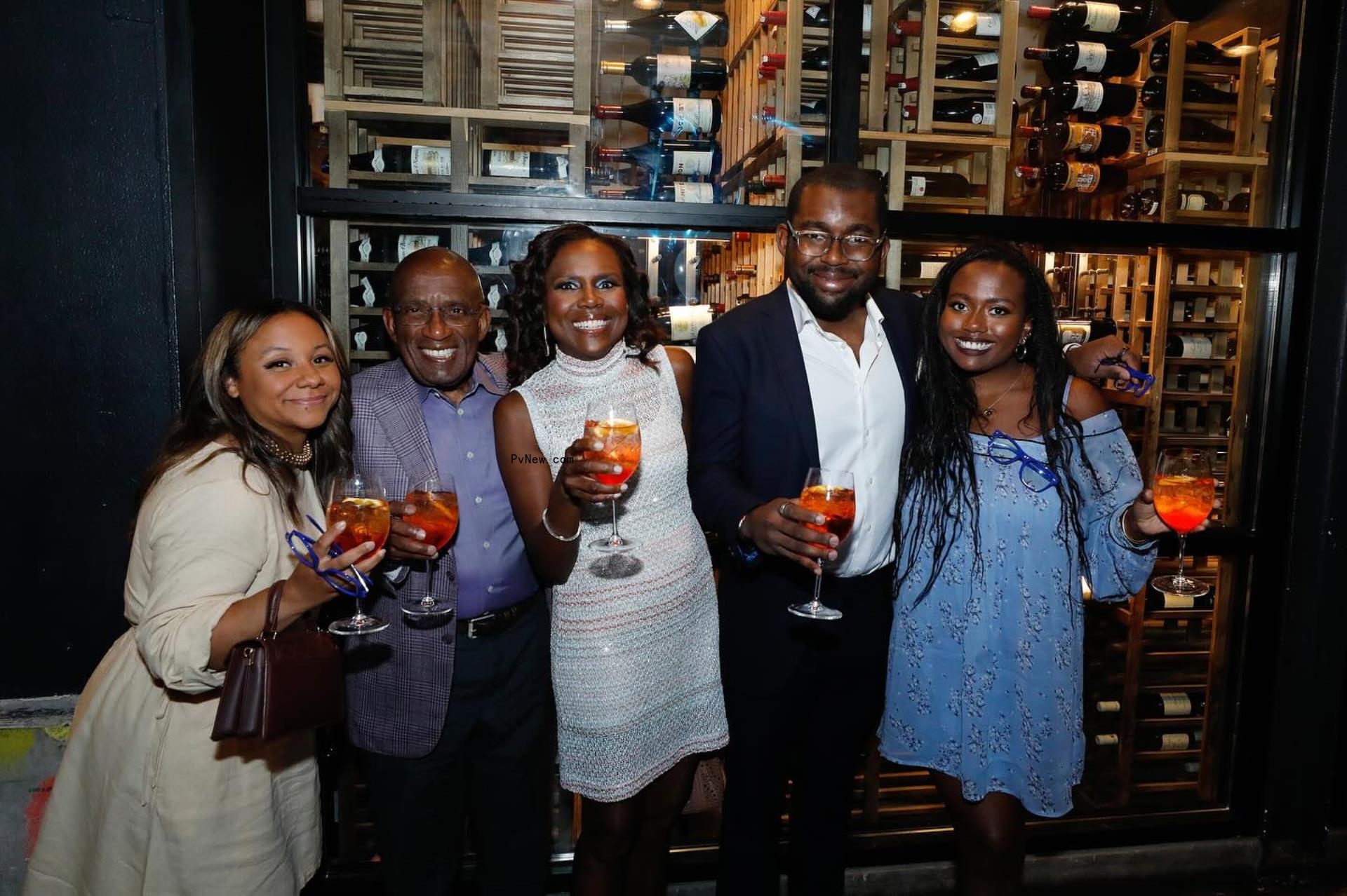 Al Roker and Deborah Roberts posing with their three kids