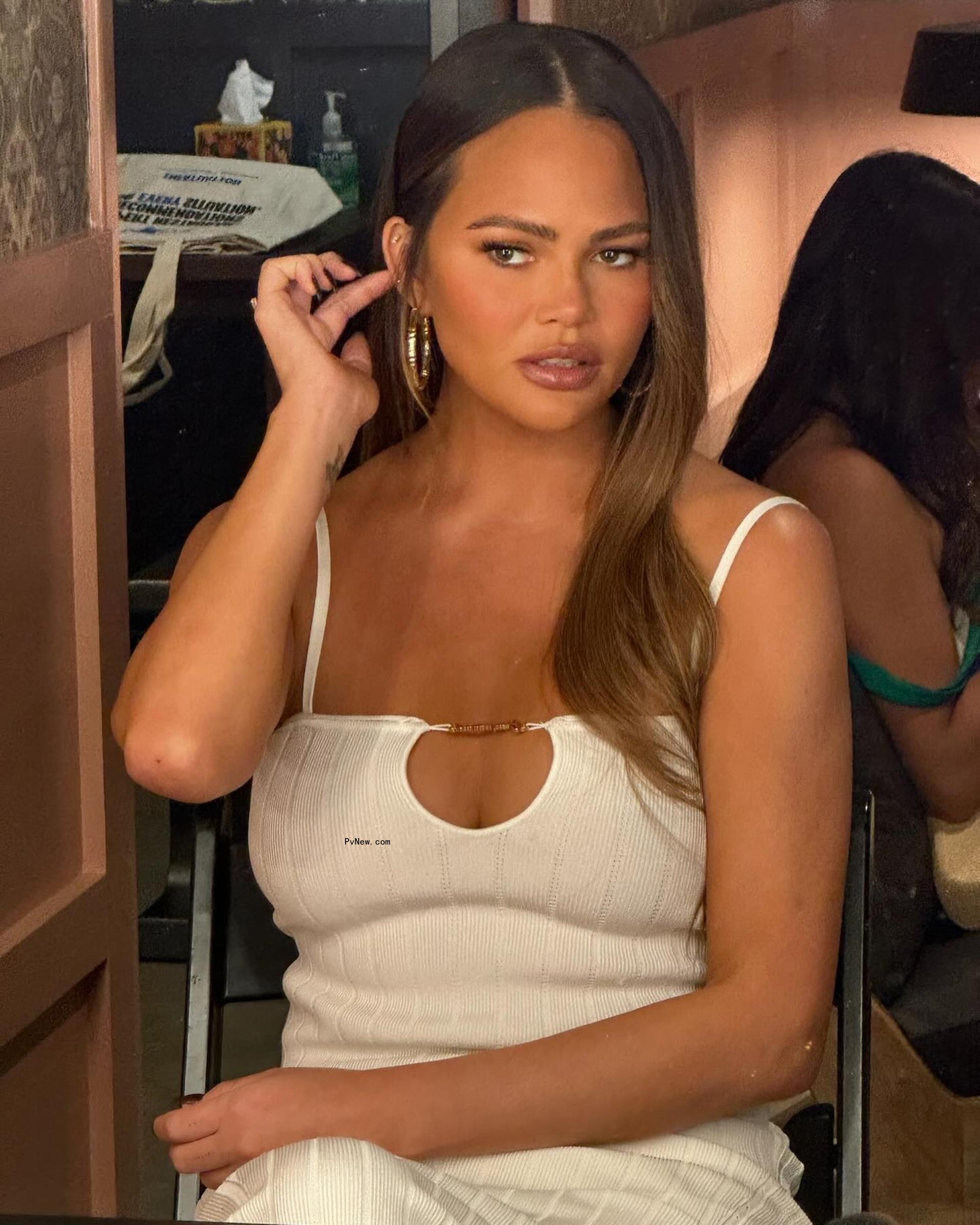 Chrissy Teigen in a white dress. 