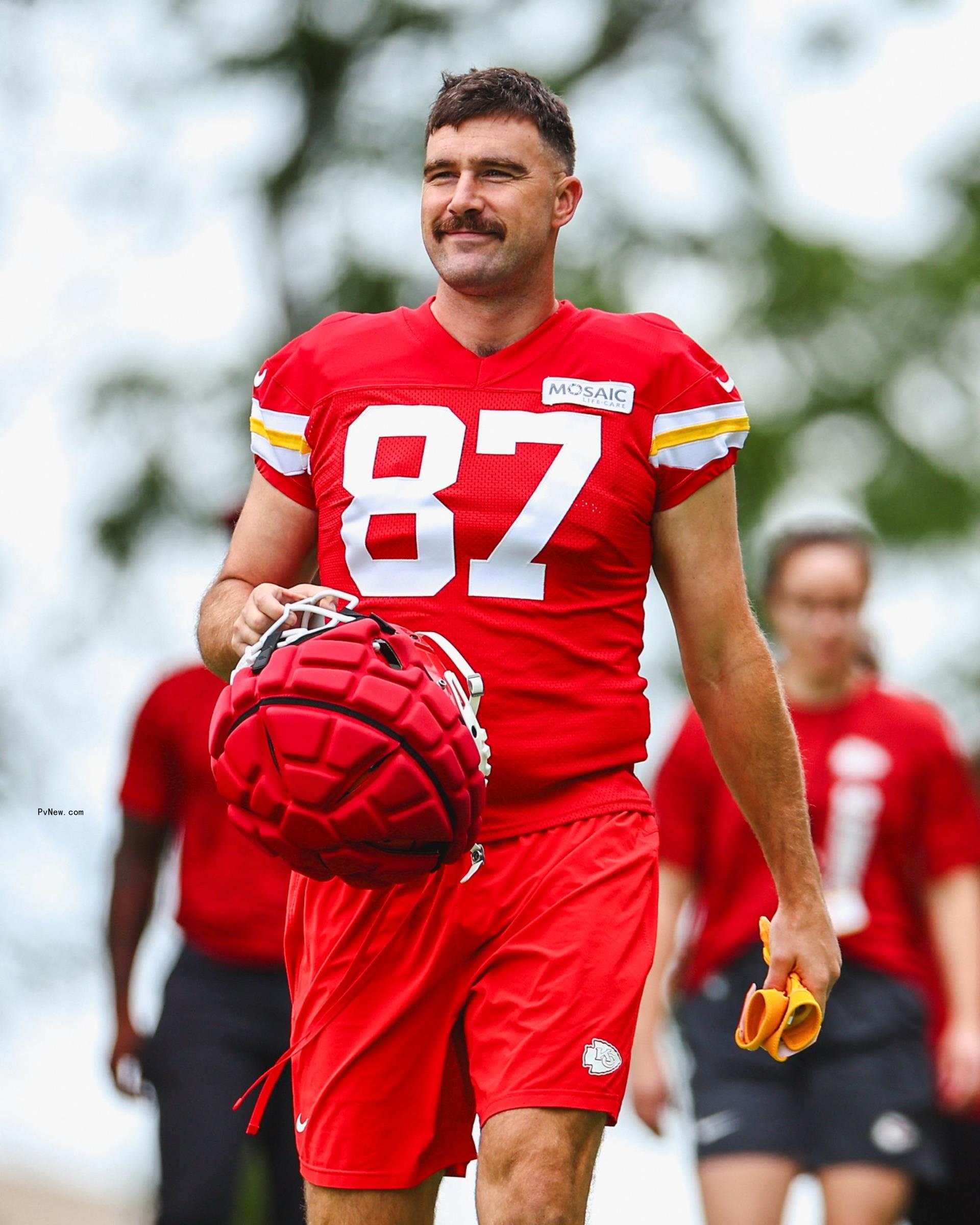 Travis Kelce walking in his football uniform