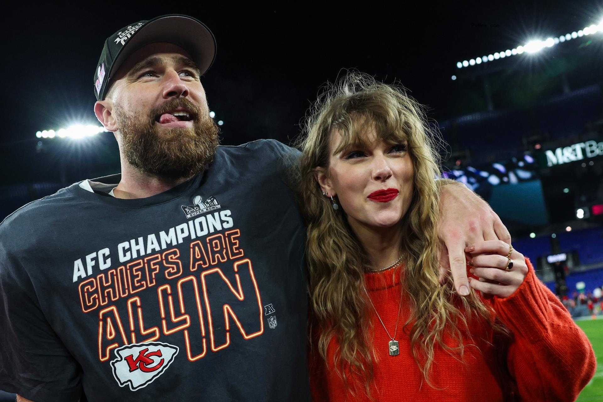 Travis Kelce and Taylor Swift posing together on a football field