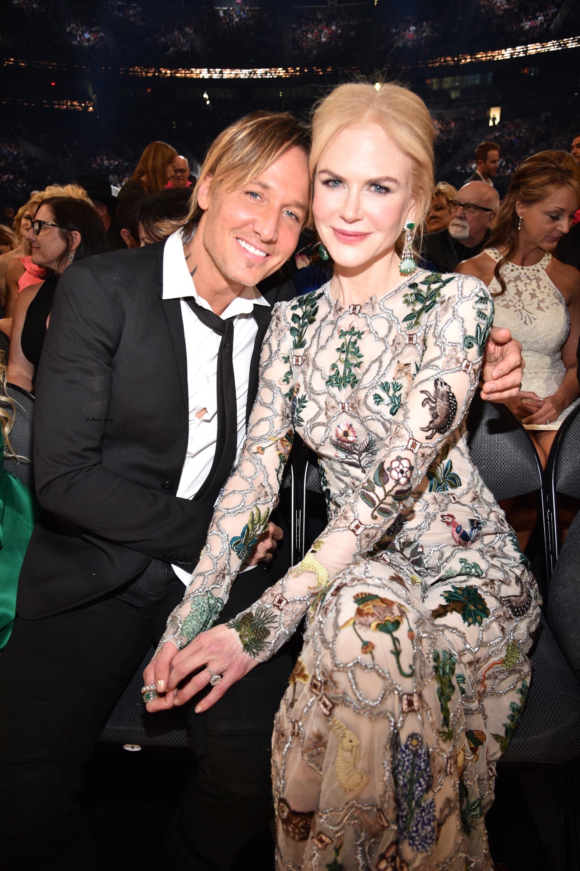 keith urban sitting on the hood of a resorted Mustang