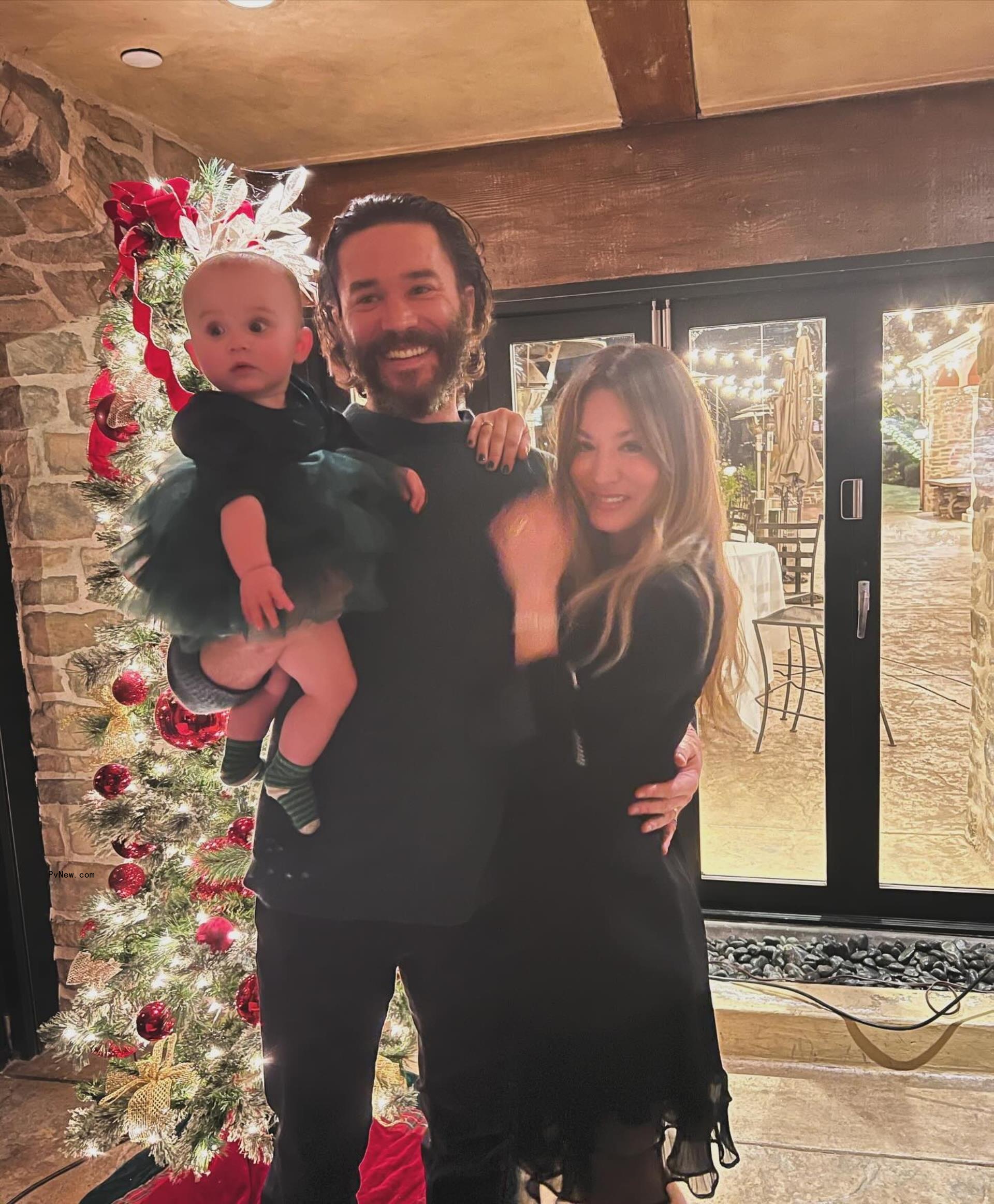 kaley cuoco, tom pelphrey and their daughter in front of a christmas tree