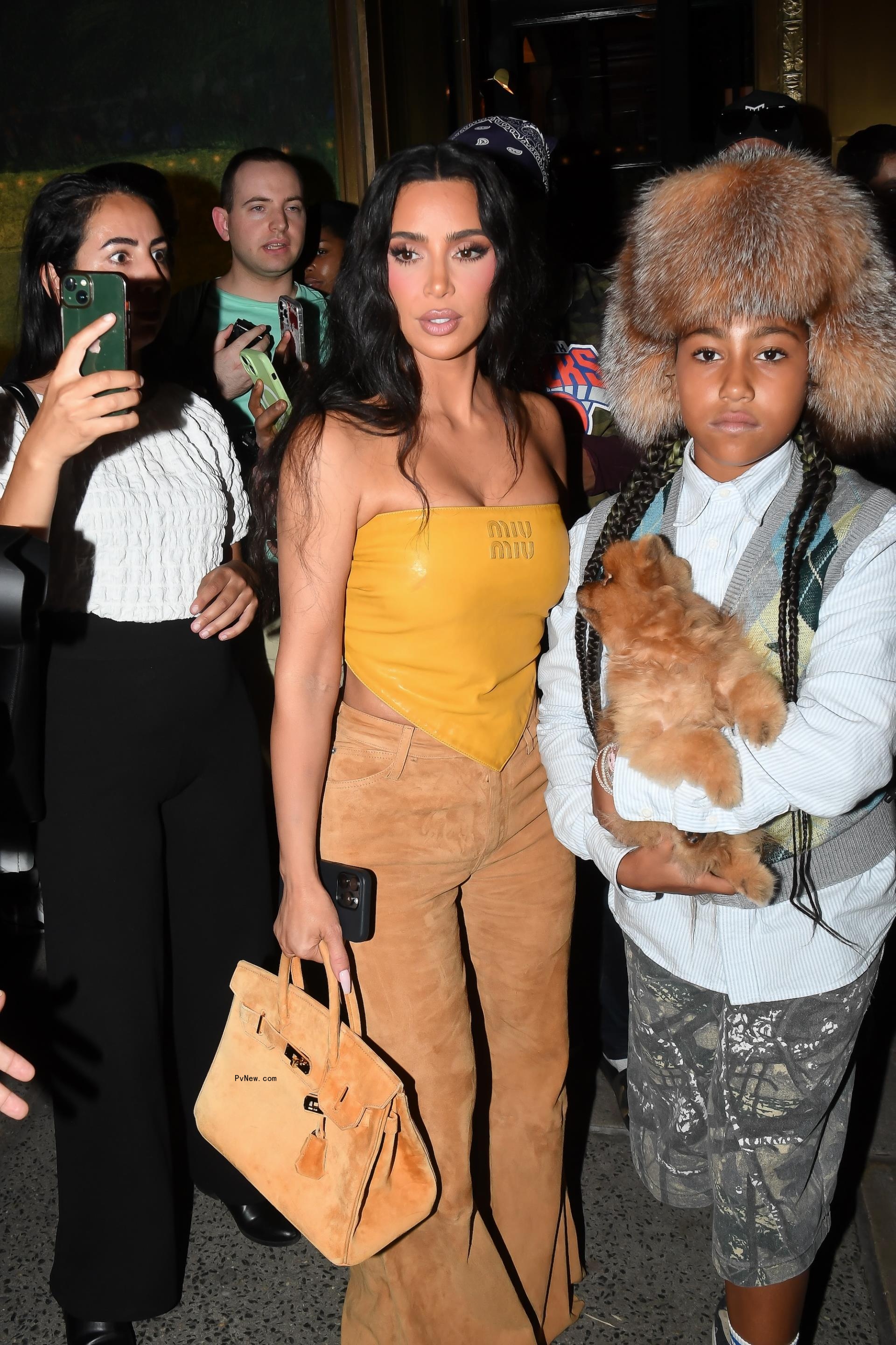 North West wearing Bianca Censori's fur hat while out in New York City with Kim Kardashian