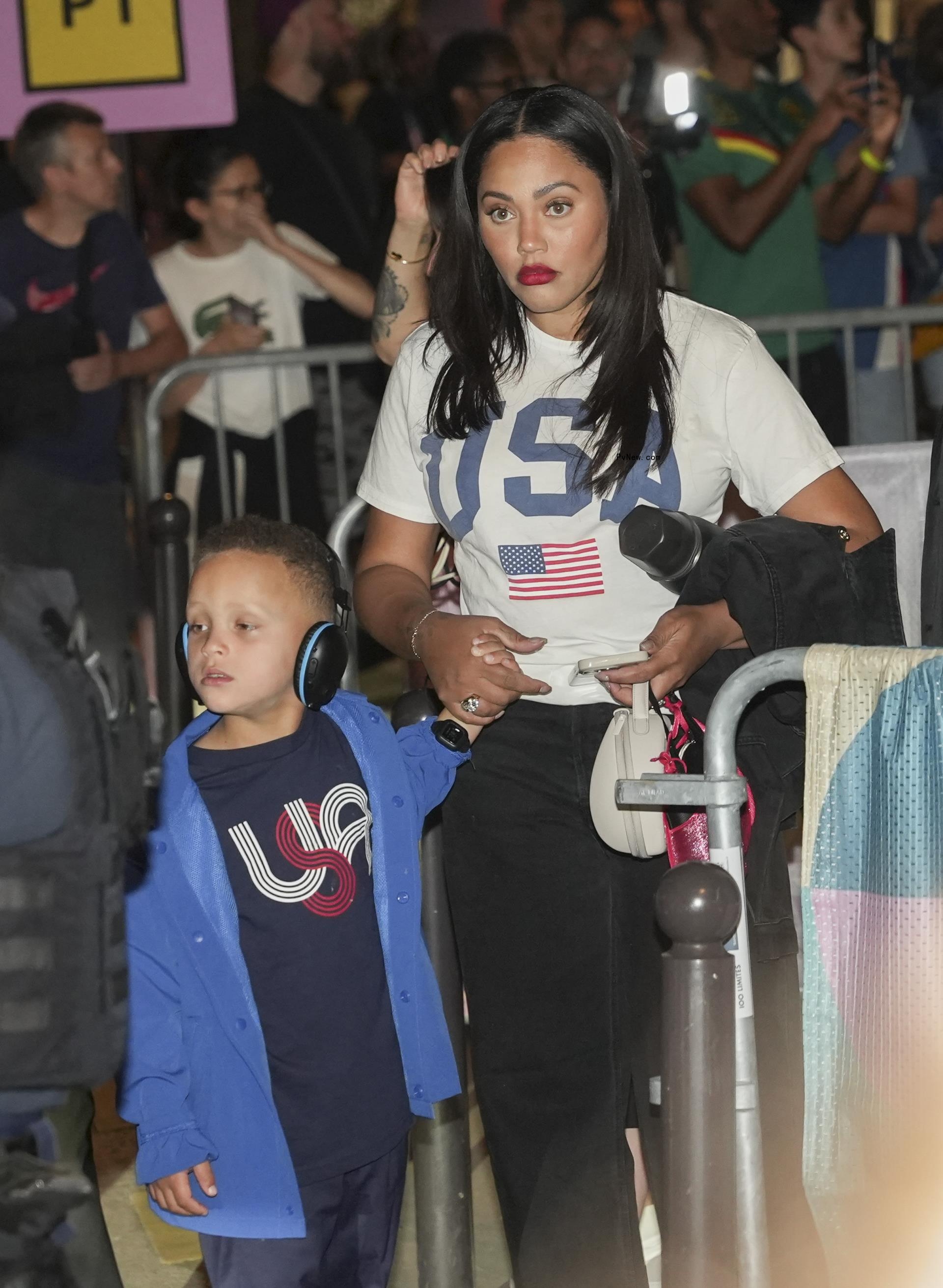 Ayesha Curry holding her son Canon's hand in Paris.