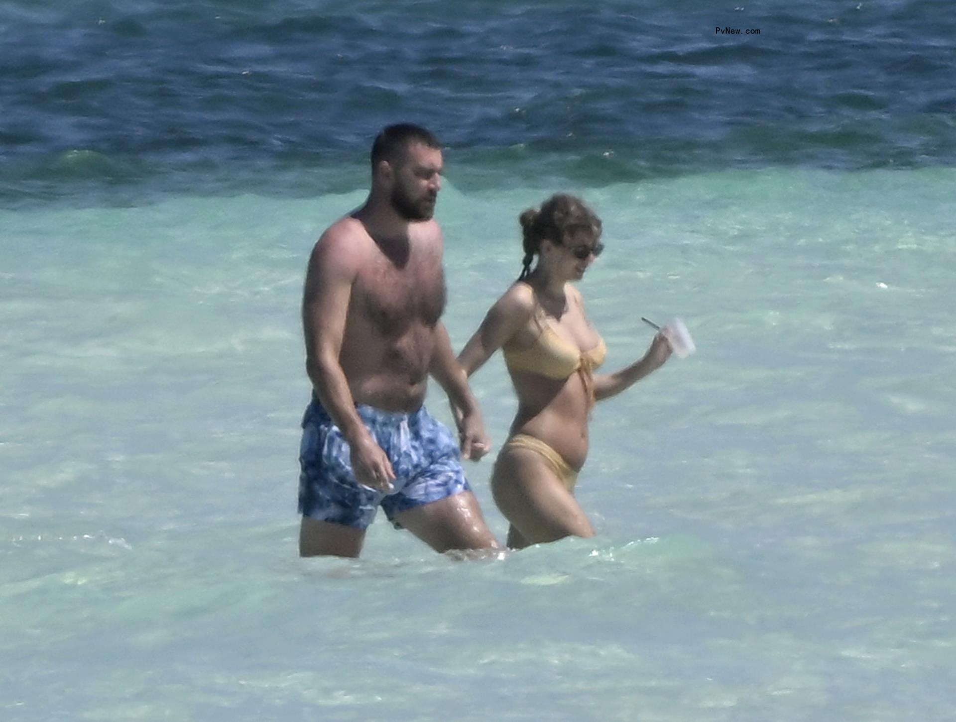 Travis Kelce and Taylor Swift walking