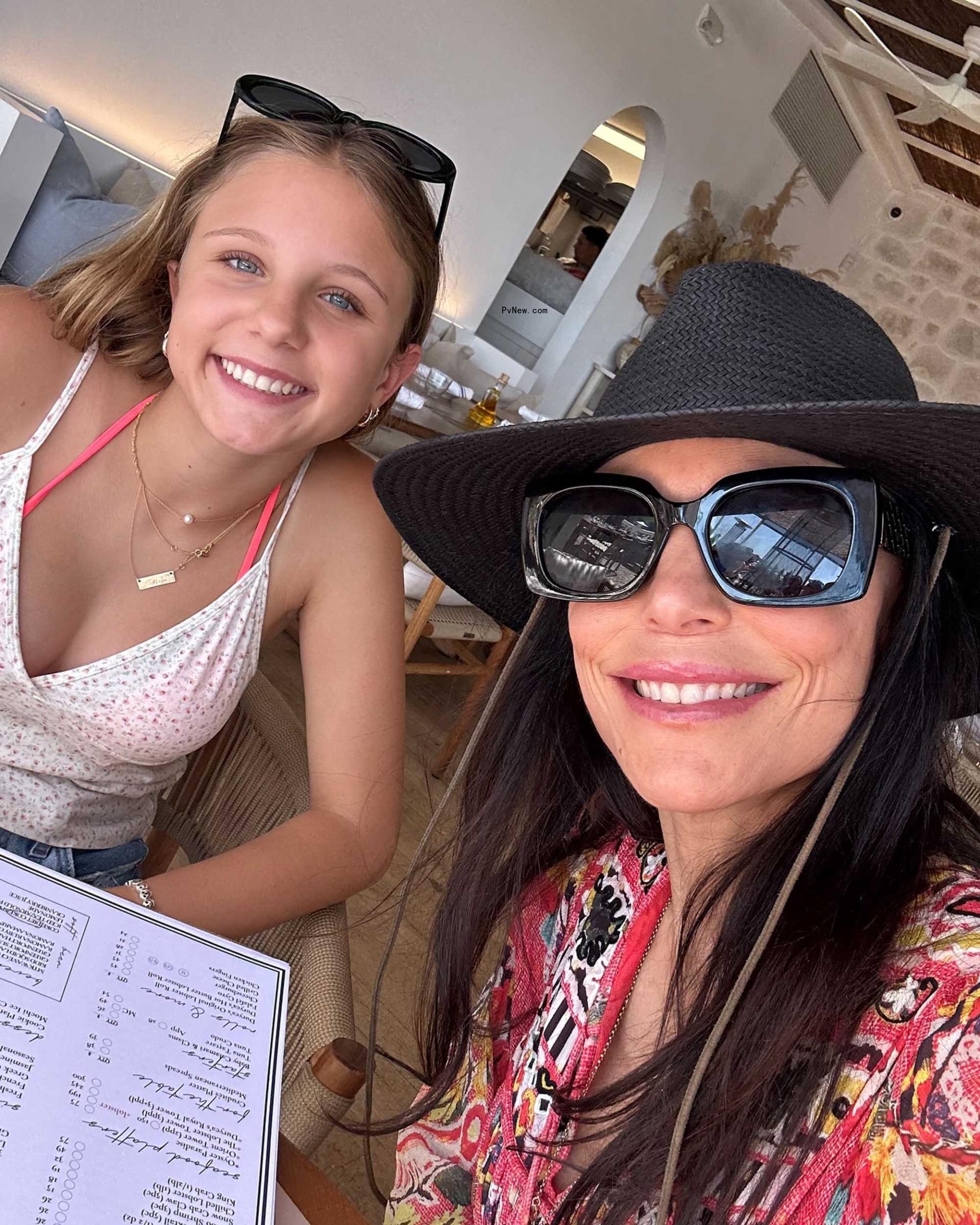 Bethenny Frankel and Bryn Hoppy posing for a selfie in a restaurant