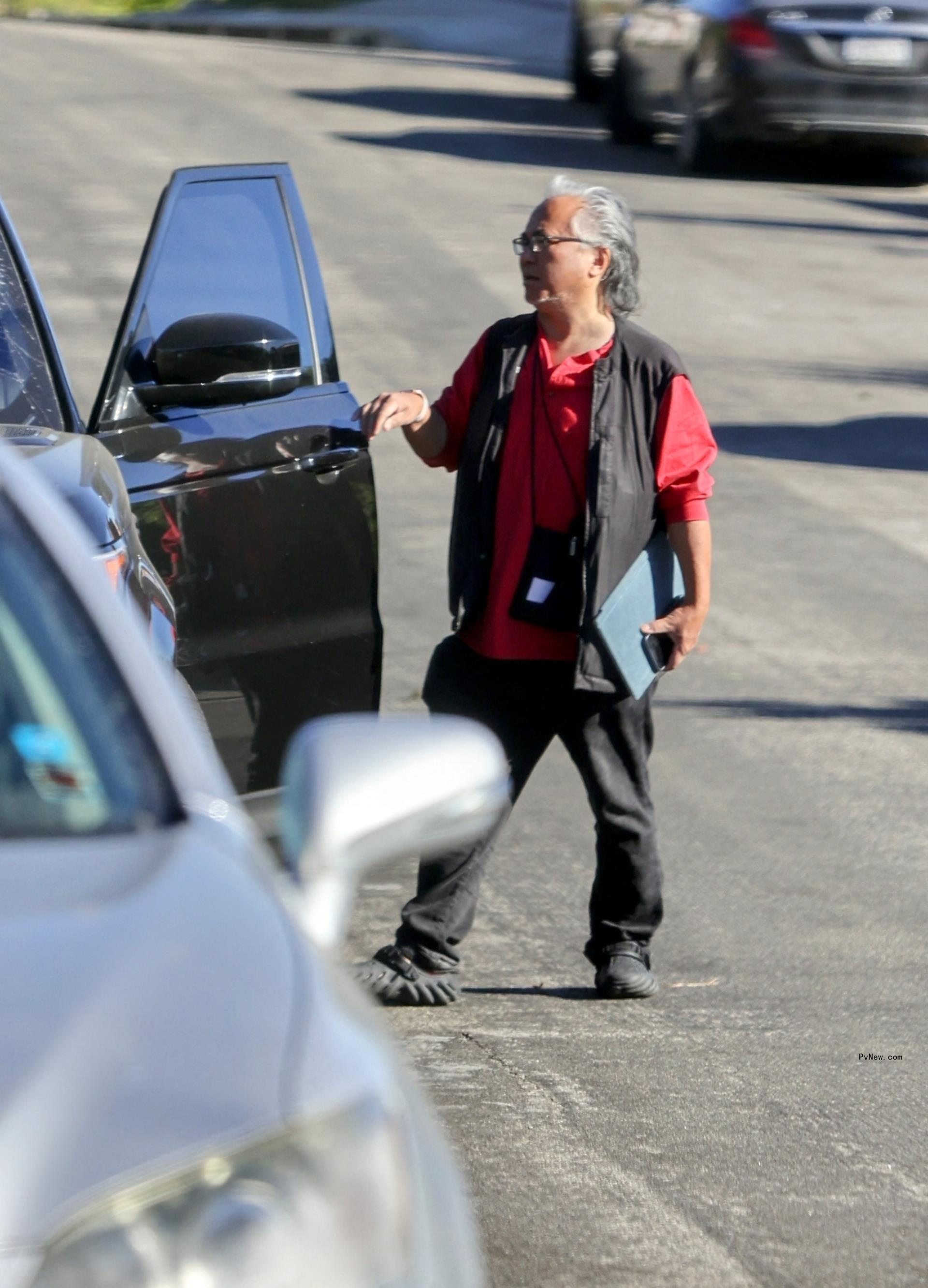 Kenny Iwamasa getting into a car.