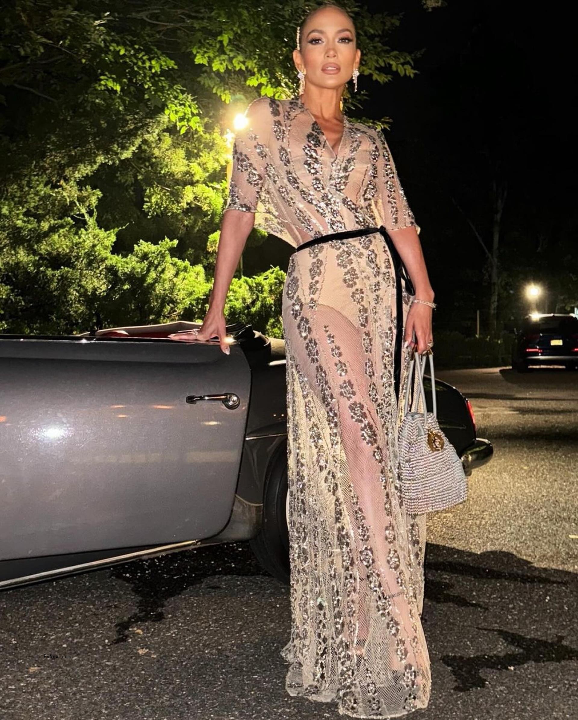 Jennifer Lopez posing in a see-through Dior gown on her 55th birthday