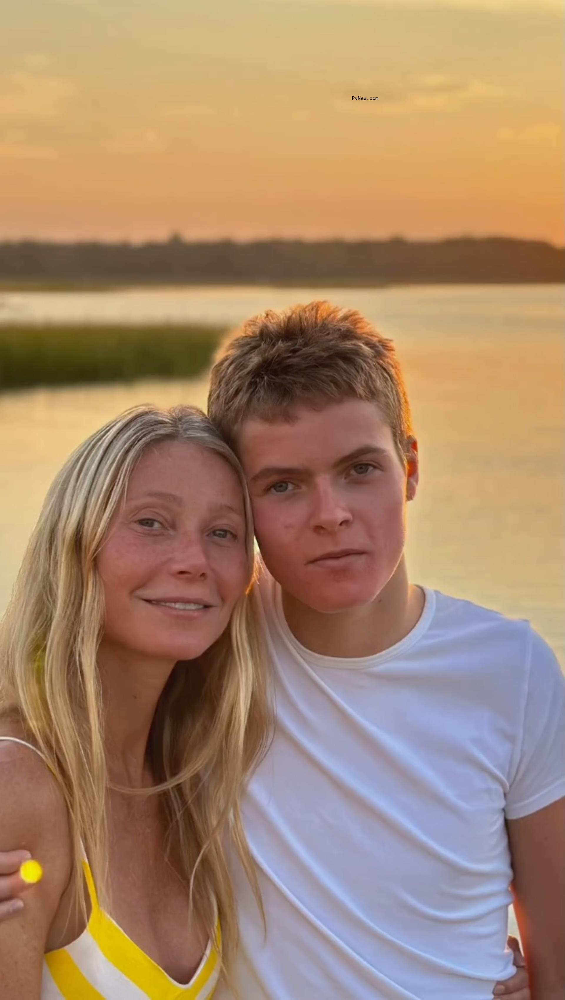 Gwyneth Paltrow and Moses Martin posing in front of a sunset. 