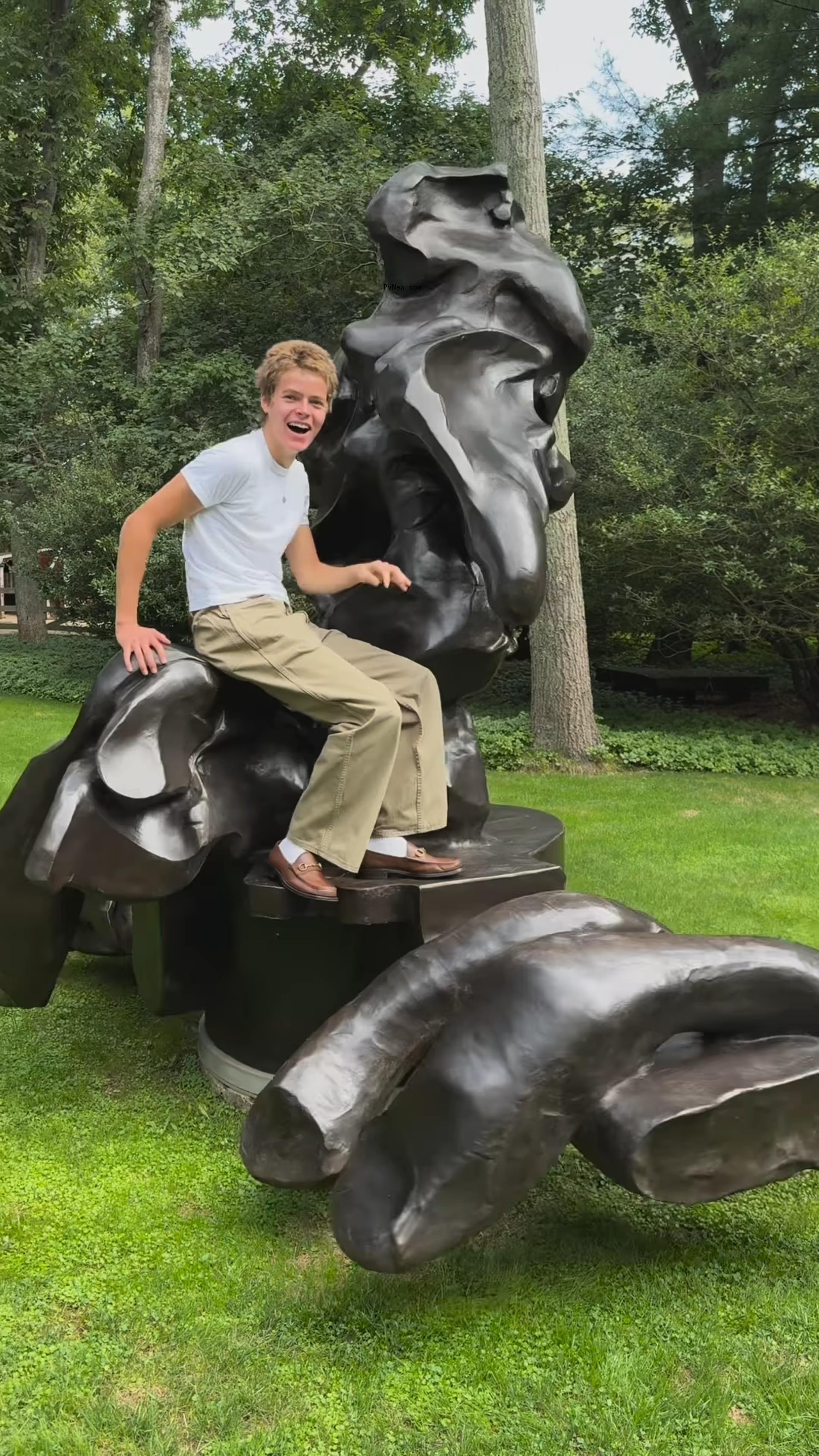 Moses Martin climbing a sculpture. 