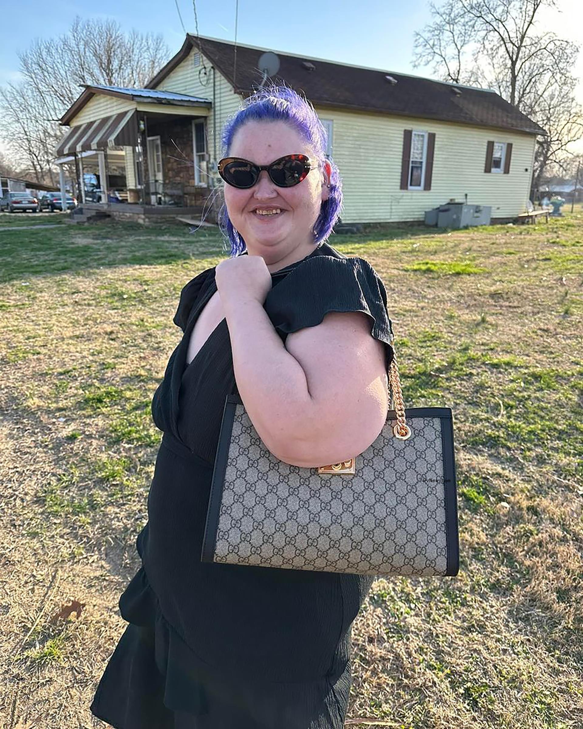 Amy Slaton holding a purse. 