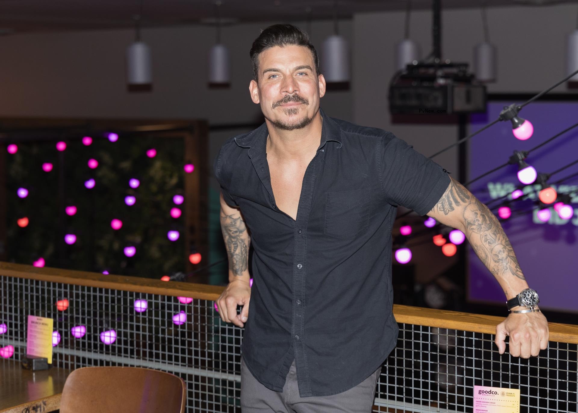 Jax taylor leaning on a bar in June 2024